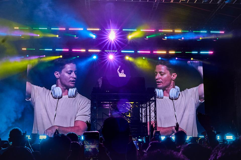 Headliner DJ performing under stage lighting