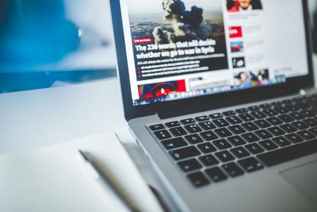 A published news article displayed on a laptop screen